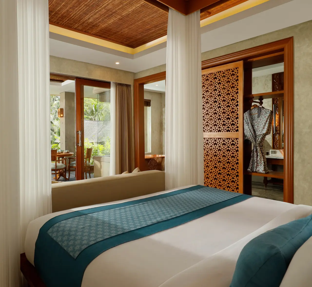A bed and pajamas in a cozy room.