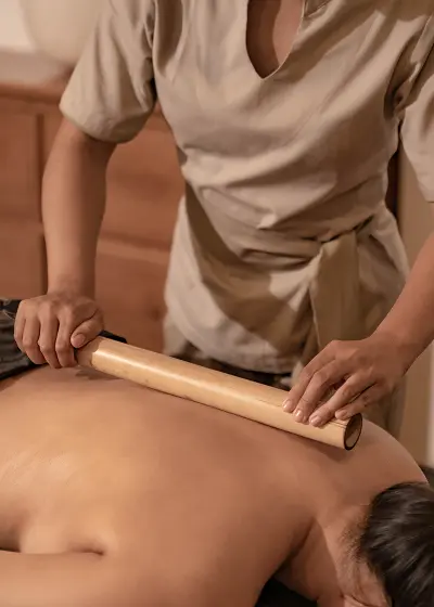 A shoulder massage using traditional tools.