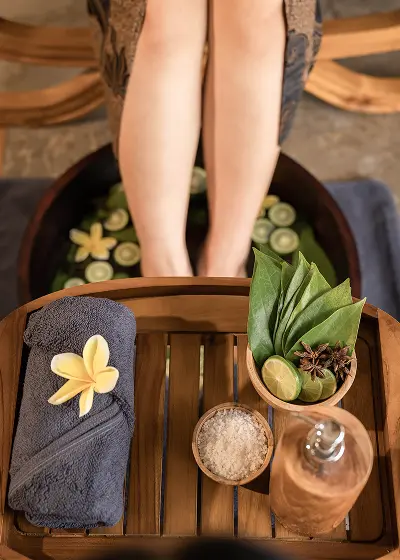 Two feet soaking in an herbal spa treatment.