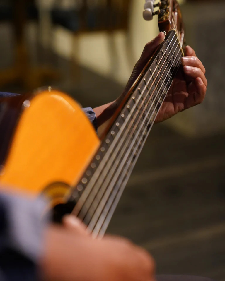 A photo of a guitar being played.