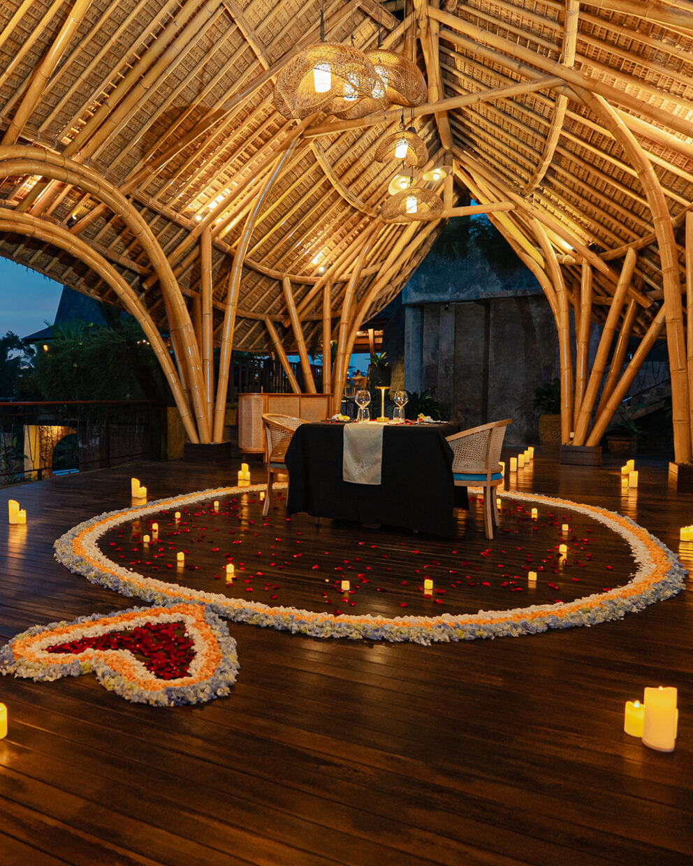 Romantic dinner settings with heart-shaped flower decorations.