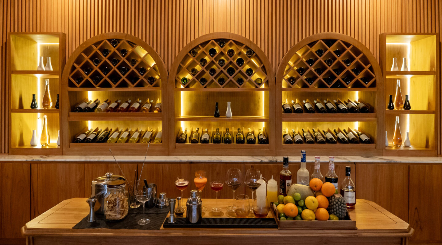 Some fruit and bottles of alcohol